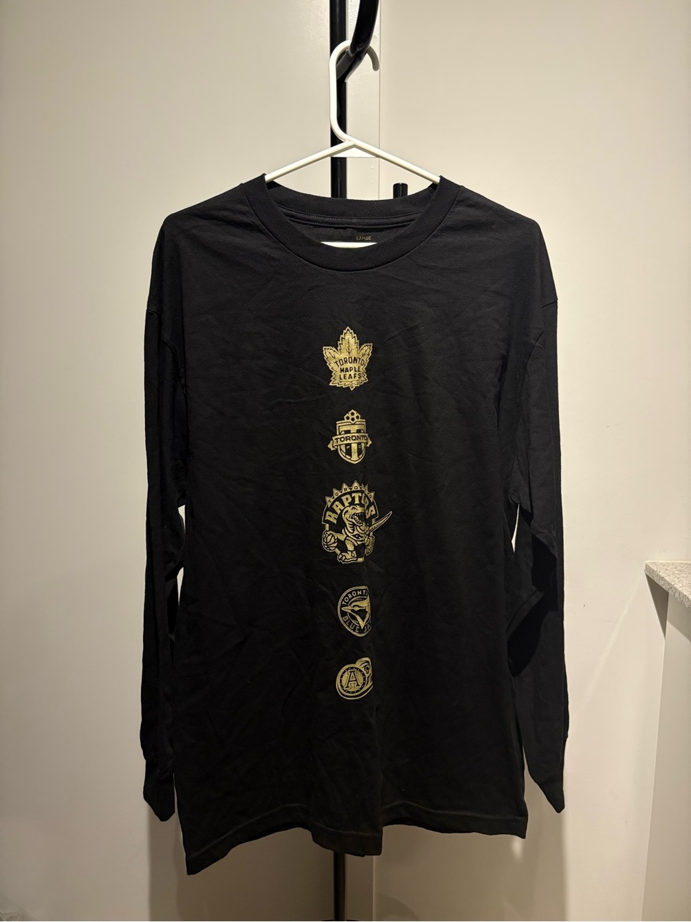 Black Long Sleeve Tee with Gold Hockey Crest Motif